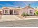 Charming single-story home featuring a light pink facade, desert landscaping, and a spacious driveway at 1633 E Jasmine St, Casa Grande, AZ 85122