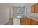 Bright kitchen featuring wood cabinets, tile flooring, and stainless-steel sink at 1633 E Jasmine St, Casa Grande, AZ 85122