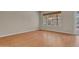Bright room with wood floors and windows looking out onto the backyard at 1633 E Jasmine St, Casa Grande, AZ 85122