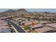 Scenic aerial view of a neighborhood with desert landscape and mountain views at 16500 W Caldwell St, Goodyear, AZ 85338