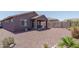 Desert landscaped backyard with covered patio and dining area at 16500 W Caldwell St, Goodyear, AZ 85338