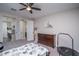 Bright bedroom with ceiling fan, dresser, and decor at 16500 W Caldwell St, Goodyear, AZ 85338