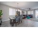 Inviting dining area with stylish chairs, a modern chandelier, and seamless access to the adjacent living room at 16500 W Caldwell St, Goodyear, AZ 85338
