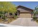 Charming home featuring a two-car garage, desert landscaping and brick driveway at 16500 W Caldwell St, Goodyear, AZ 85338