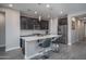 Bright kitchen featuring a central island with bar seating, stainless steel appliances, and stylish pendant lighting at 16500 W Caldwell St, Goodyear, AZ 85338