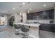 Modern kitchen featuring stainless steel appliances, quartz countertops, and an island with bar seating at 16500 W Caldwell St, Goodyear, AZ 85338