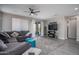 Spacious living room featuring a cozy sectional sofa, stylish area rug, and sliding glass doors to the outdoors at 16500 W Caldwell St, Goodyear, AZ 85338