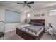 Cozy primary bedroom featuring a comfortable bed, neutral decor, and a ceiling fan at 16500 W Caldwell St, Goodyear, AZ 85338