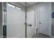 Modern shower with glass door, tiled floor and window at 16500 W Caldwell St, Goodyear, AZ 85338