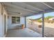Covered patio with a hammock, table, and chairs, offering a relaxing outdoor space at 1657 N 55Th Ave, Phoenix, AZ 85035