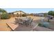 Spacious backyard featuring a patio table with chairs and a rocking chair at 1657 N 55Th Ave, Phoenix, AZ 85035