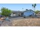 Large backyard with a covered patio, open space, and mature trees at 1657 N 55Th Ave, Phoenix, AZ 85035