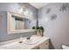 Well-lit bathroom with a stylish sink, marble countertop, and decorative starburst wall art at 1657 N 55Th Ave, Phoenix, AZ 85035