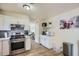 Bright kitchen boasts stainless steel appliances and wood-look tile floors at 1657 N 55Th Ave, Phoenix, AZ 85035