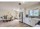 Open kitchen and dining area features wood-look tile floors and stainless steel appliances at 1657 N 55Th Ave, Phoenix, AZ 85035