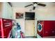 Laundry room featuring red washer and dryer units and overhead lighting at 1657 N 55Th Ave, Phoenix, AZ 85035