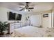 The main bedroom features a ceiling fan and ensuite bathroom at 1657 N 55Th Ave, Phoenix, AZ 85035