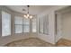 Bright dining area with tile floors, chandelier, and plenty of natural light from multiple windows at 171 W Hawaii Dr, Casa Grande, AZ 85122