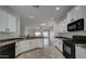 Modern kitchen with white cabinets, stainless steel appliances, and a breakfast bar at 171 W Hawaii Dr, Casa Grande, AZ 85122