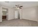 Spacious bedroom with a ceiling fan and an ensuite bathroom entrance at 17878 N 114Th Ln, Surprise, AZ 85378