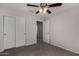 Bedroom featuring carpet, ceiling fan, closet, and doorway to the rest of the house at 17878 N 114Th Ln, Surprise, AZ 85378