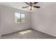 Bedroom featuring carpet, ceiling fan and multiple windows for ample natural light at 17878 N 114Th Ln, Surprise, AZ 85378