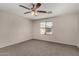 Bright bedroom with a ceiling fan and a large window at 17878 N 114Th Ln, Surprise, AZ 85378