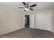 Bedroom featuring carpet, ceiling fan, closet, and doorway to the rest of the house at 17878 N 114Th Ln, Surprise, AZ 85378