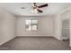 Bright bedroom featuring a ceiling fan and a large window with neighborhood views at 17878 N 114Th Ln, Surprise, AZ 85378