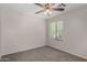 Bright bedroom featuring plush carpeting, ceiling fan and a large window at 17878 N 114Th Ln, Surprise, AZ 85378