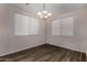 Elegant dining room with two windows and gray wood floors at 17878 N 114Th Ln, Surprise, AZ 85378