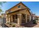 Charming two-story home featuring a cozy front porch with arched columns and a well-maintained yard at 17878 N 114Th Ln, Surprise, AZ 85378