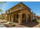 Inviting two-story home featuring a covered porch with stylish columns and low maintenance desert landscaping at 17878 N 114Th Ln, Surprise, AZ 85378
