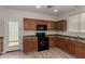 Updated kitchen showcases wood cabinets, modern appliances, and backyard access at 17878 N 114Th Ln, Surprise, AZ 85378