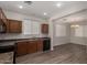 Bright kitchen featuring wood cabinets, updated appliances, and an adjacent dining area at 17878 N 114Th Ln, Surprise, AZ 85378