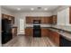 Functional kitchen with wood cabinets, black appliances, and durable countertops at 17878 N 114Th Ln, Surprise, AZ 85378