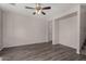 Neutral living room showcasing gray wood floors, ceiling fan, and an open layout at 17878 N 114Th Ln, Surprise, AZ 85378