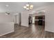Spacious living area connects seamlessly to the kitchen, creating an open floor plan, with gray wood floors at 17878 N 114Th Ln, Surprise, AZ 85378