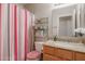 Bathroom featuring a toilet, decorative shower curtain, and light wood cabinets at 18116 N Catherine Dr, Surprise, AZ 85374