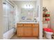 Bright bathroom with a shower-tub combination, a wood vanity with countertop, and pink accents at 18116 N Catherine Dr, Surprise, AZ 85374