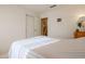 Bedroom featuring a bed, closet with white doors, and views of the bathroom at 18116 N Catherine Dr, Surprise, AZ 85374