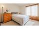 Cozy bedroom featuring a bright window, carpet, and wooden nightstand at 18116 N Catherine Dr, Surprise, AZ 85374