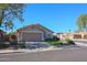 Charming single-story home featuring a well-maintained front yard and a two-car garage at 18116 N Catherine Dr, Surprise, AZ 85374
