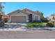 Inviting single-story home featuring a well-kept lawn, mature landscaping, and a two-car garage at 18116 N Catherine Dr, Surprise, AZ 85374