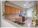 Galley kitchen view showcasing wood cabinets, black appliances, and neutral countertops at 18116 N Catherine Dr, Surprise, AZ 85374