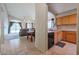 Cozy kitchen featuring wood cabinets and black appliances, adjacent to the dining area and living room at 18116 N Catherine Dr, Surprise, AZ 85374
