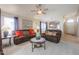 Inviting living room featuring plush seating, bright light, and access to the kitchen and dining area at 18116 N Catherine Dr, Surprise, AZ 85374