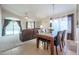 Inviting living room featuring plush seating, vaulted ceilings, and a sliding glass door to the backyard at 18116 N Catherine Dr, Surprise, AZ 85374