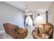 Bright and airy living room with a ceiling fan, access to the backyard, and comfortable seating at 18116 N Catherine Dr, Surprise, AZ 85374