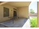 Covered patio area with an outdoor dining table and access to the backyard at 18116 N Catherine Dr, Surprise, AZ 85374